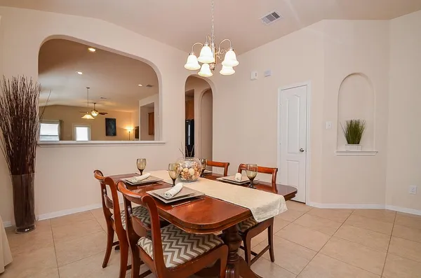 a view of a dining room with furniture and chandelier