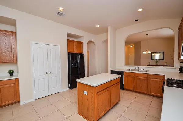 a large kitchen with stainless steel appliances granite countertop a large counter top and a stove
