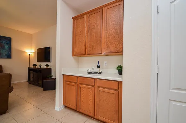 a view of a kitchen with fridge and workspace