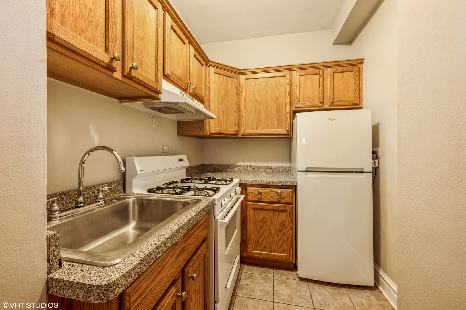6101 North Sheridan Road, Unit 10G Chicago, IL 60660 - Photo 5 of 10 a kitchen with a sink a refrigerator and cabinets