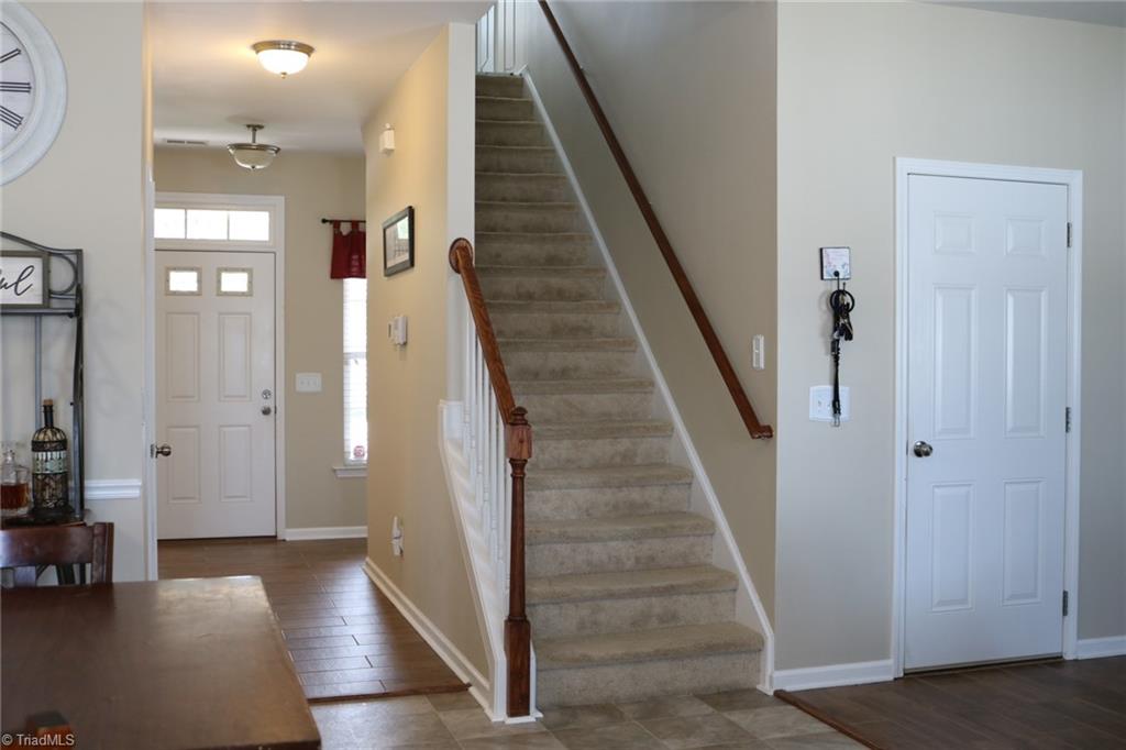 4547 Silo Ridge Clemmons, NC 27012 - Photo 12 of 37 Foyer, stairs to upper level, door to garage