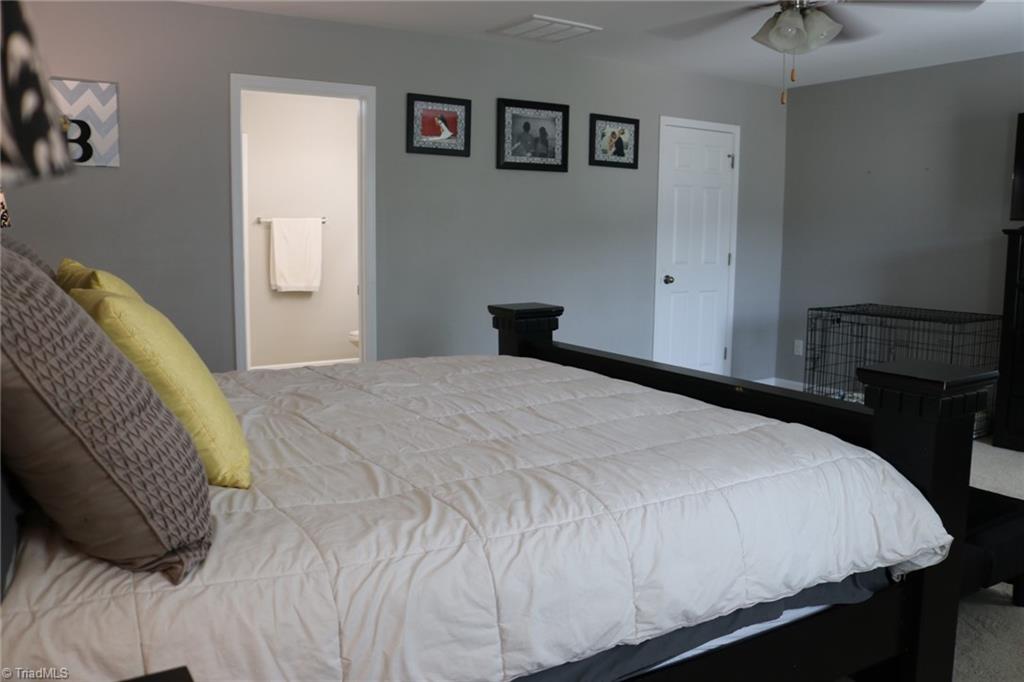 4547 Silo Ridge Clemmons, NC 27012 - Photo 14 of 37 Primary bedroom, closed door goes to walk in closet, open door to bathroom