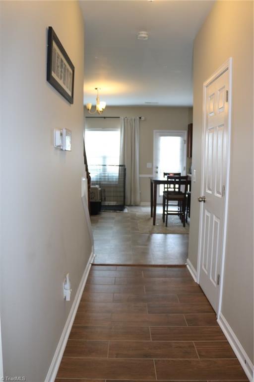 4547 Silo Ridge Clemmons, NC 27012 - Photo 36 of 37 Hallway to open floor plan livingroom/kitchen area. Door to the right is the half bath.