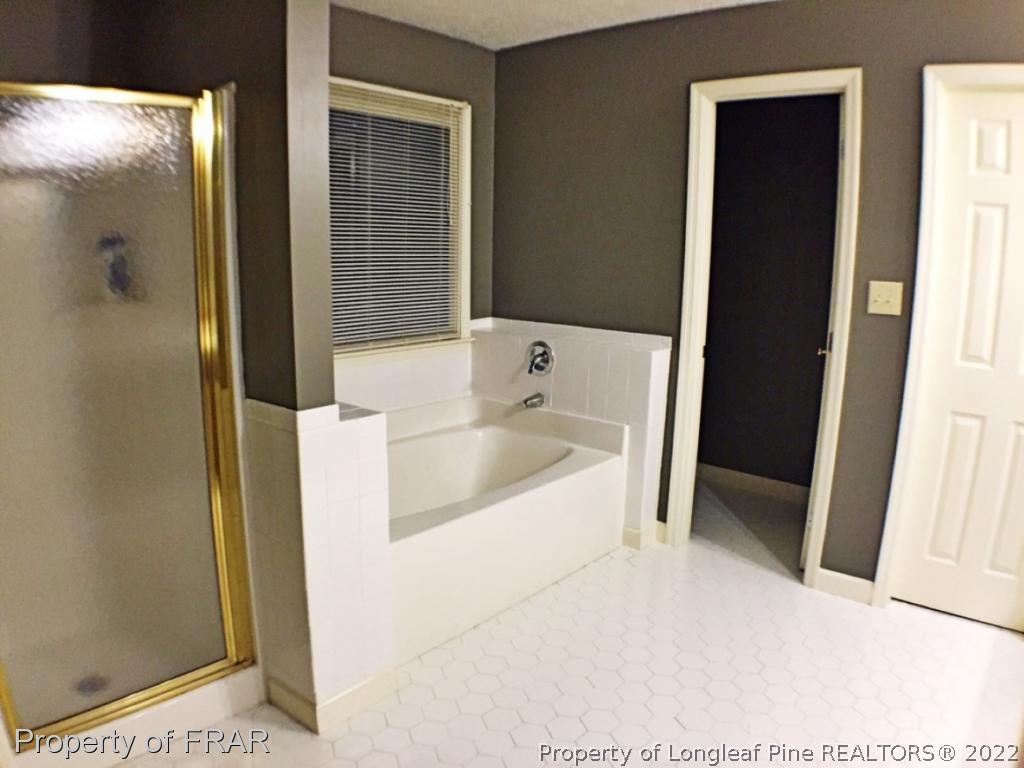 6250 Kirkwall Road Fayetteville, NC 28311 - Photo 11 of 16 a bathroom with a bathtub and a shower
