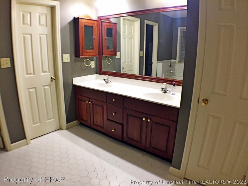 6250 Kirkwall Road Fayetteville, NC 28311 - Photo 12 of 16 a bathroom with a double vanity sink and a mirror