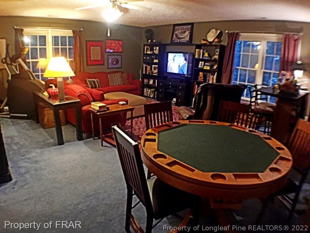 6250 Kirkwall Road Fayetteville, NC 28311 - Photo 13 of 16 a dining room with furniture a rug and a window