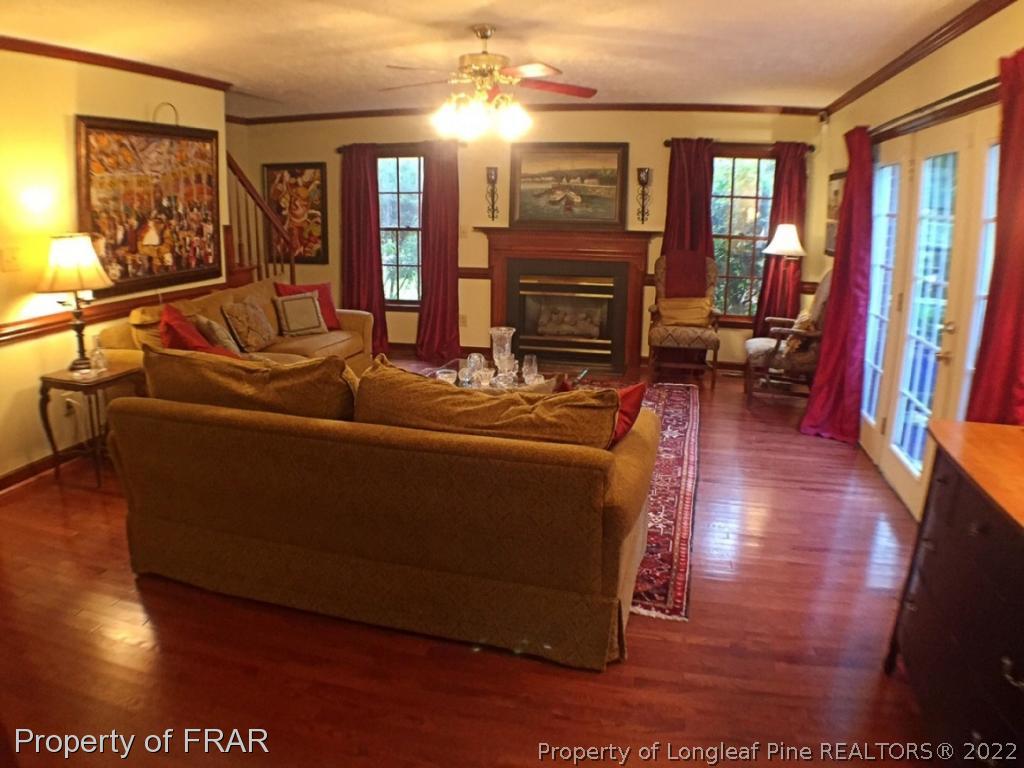 6250 Kirkwall Road Fayetteville, NC 28311 - Photo 2 of 16 a living room with furniture a fireplace and a flat screen tv