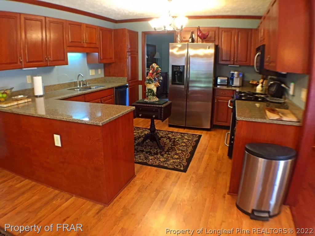 6250 Kirkwall Road Fayetteville, NC 28311 - Photo 4 of 16 a kitchen with stainless steel appliances granite countertop a refrigerator and a sink
