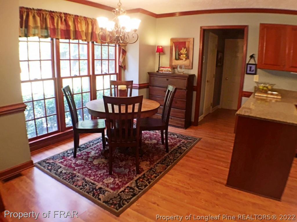 6250 Kirkwall Road Fayetteville, NC 28311 - Photo 5 of 16 a view of a dining room with furniture window and wooden floor