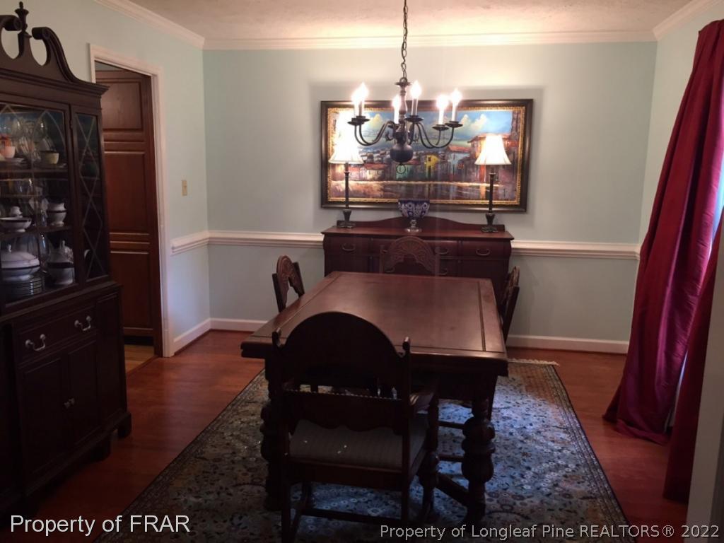 6250 Kirkwall Road Fayetteville, NC 28311 - Photo 6 of 16 a view of a dining room with furniture and wooden floor