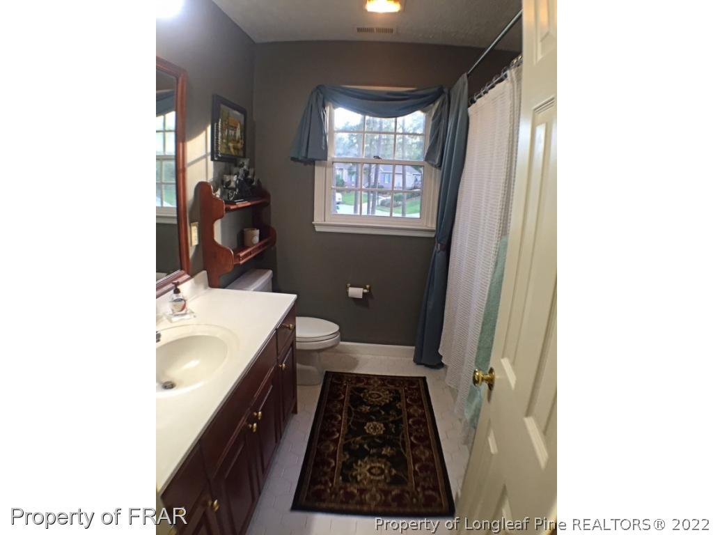 6250 Kirkwall Road Fayetteville, NC 28311 - Photo 8 of 16 a bathroom with a sink and a mirror