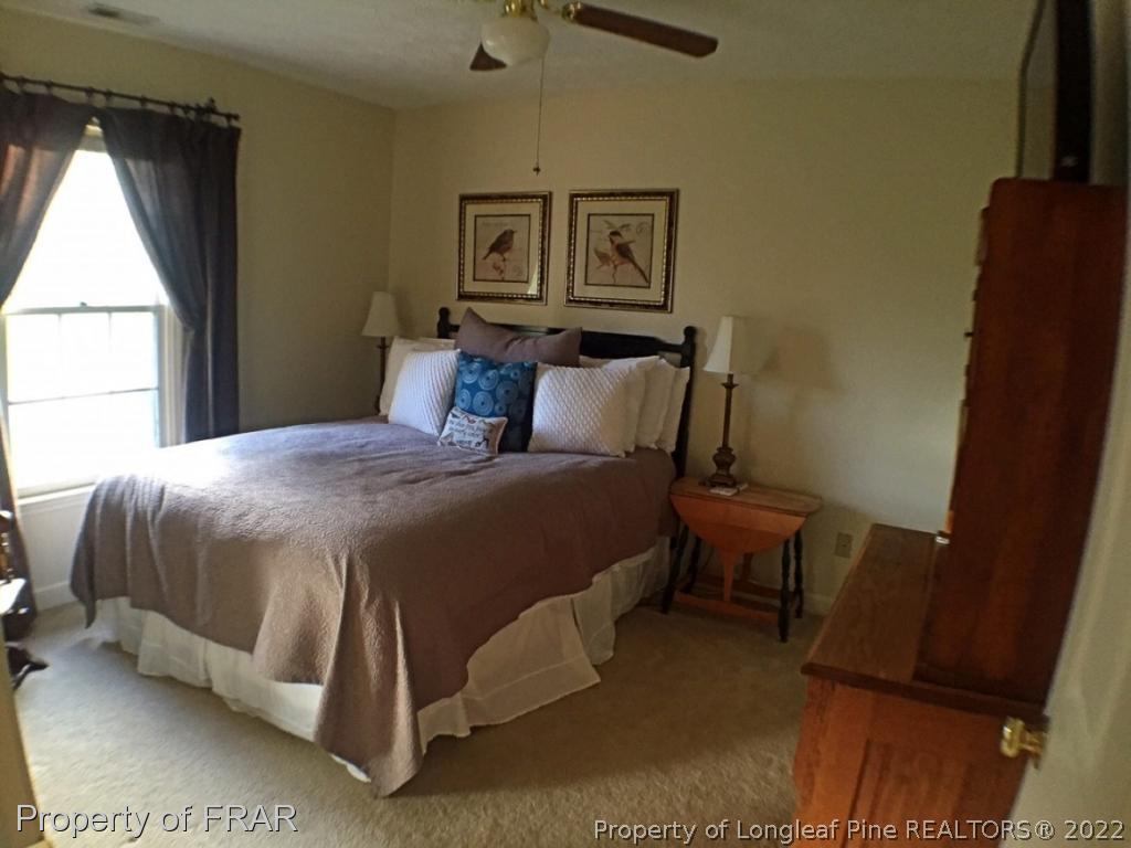 6250 Kirkwall Road Fayetteville, NC 28311 - Photo 10 of 16 a bedroom with a bed chair and window