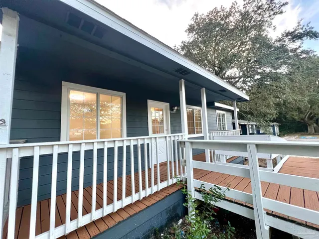 a view of a wooden deck and a yard