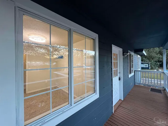 a view of a porch with wooden floor and outdoor space