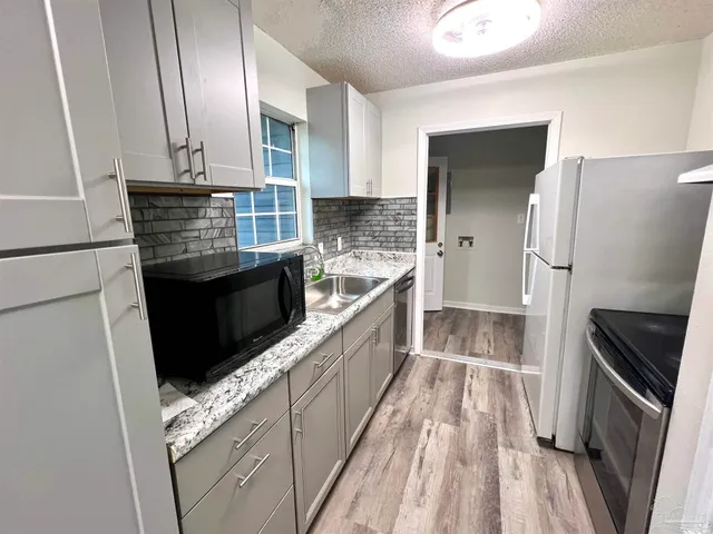 a view of a kitchen with electric appliances