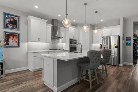 a view of walk in closet with clothes