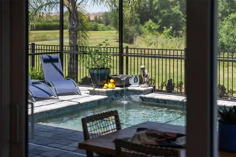 a view of a livingroom with wooden floor and a flat screen tv