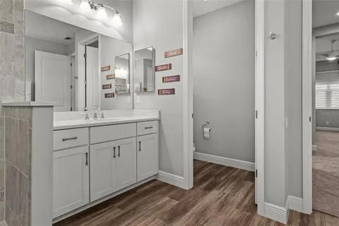 a view of a patio with table and chairs with wooden floor and fence