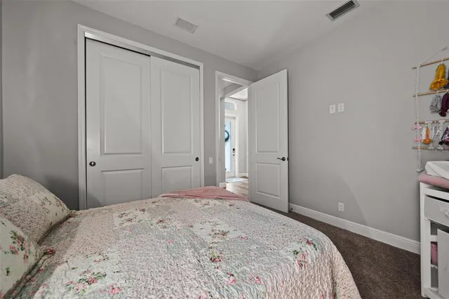 a view of a swimming pool with a table and chairs under an umbrella