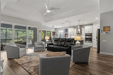 a kitchen with kitchen island a dining table chairs sink and cabinets