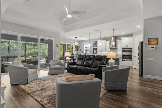 a kitchen with kitchen island a dining table chairs sink and cabinets