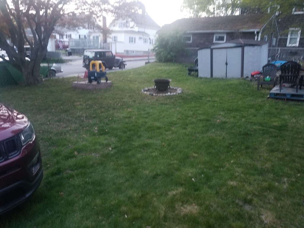 312 Anthony Fall River Fall River, MA 02721 - Photo 19 of 19 a view of a backyard with table and chairs and a fire pit