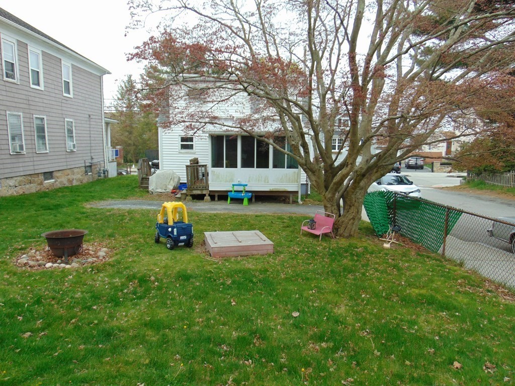 312 Anthony Fall River Fall River, MA 02721 - Photo 7 of 19 a front view of a house with backyard sitting area and garden