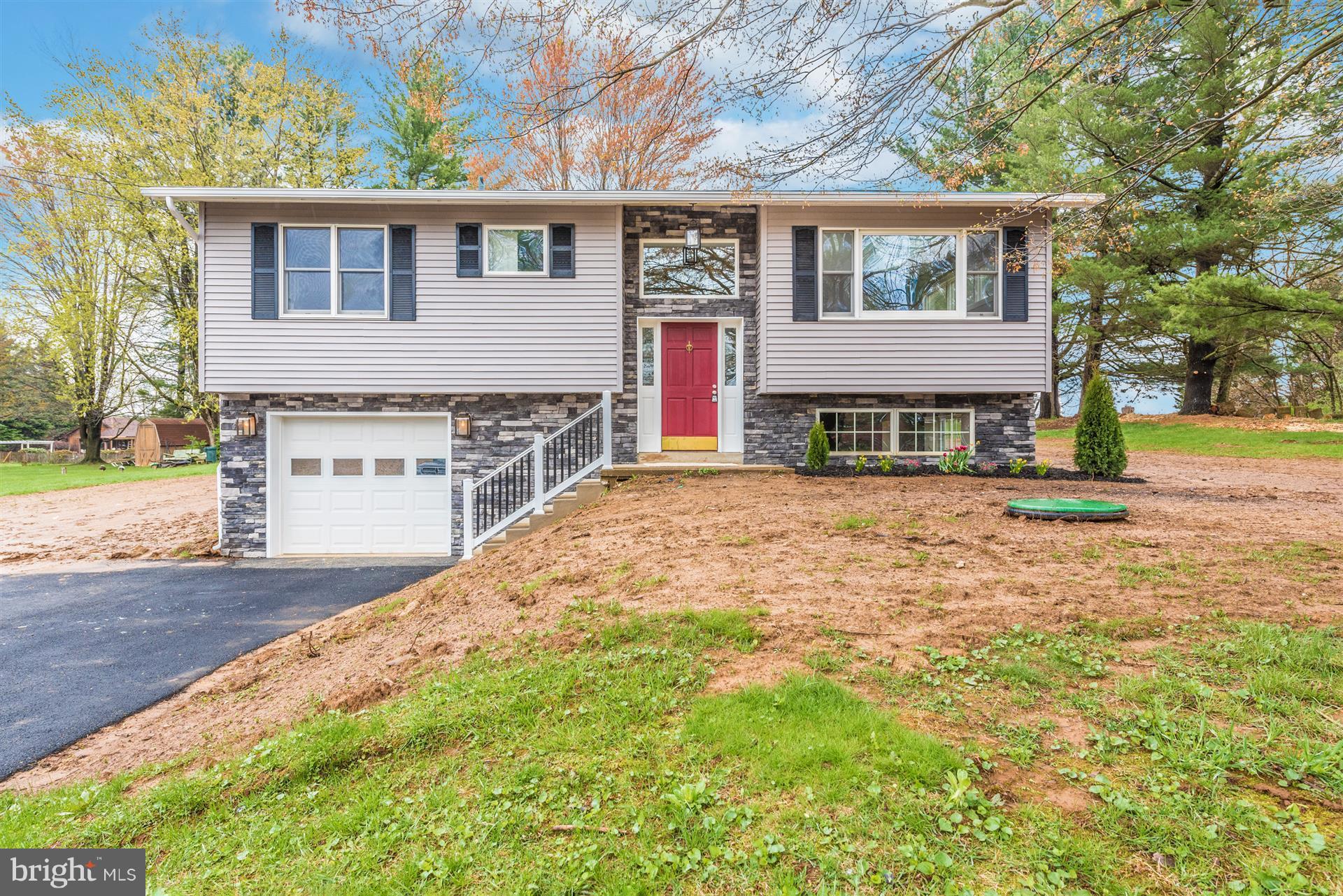 5008 Teen Barnes Road Frederick, MD 21703 - Photo 1 of 30 a front view of a house with a yard and garage