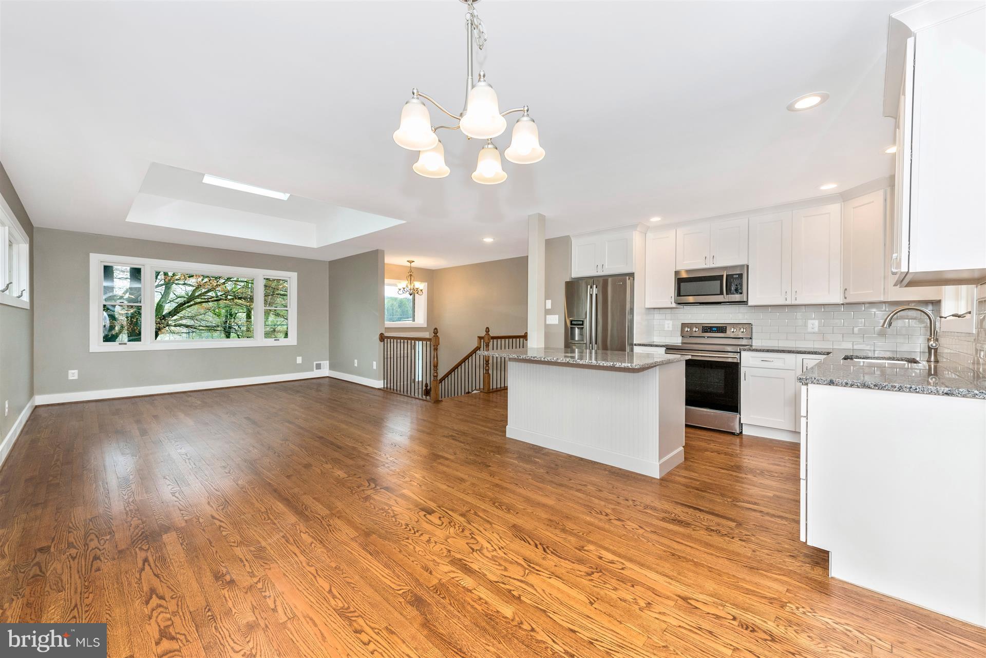 5008 Teen Barnes Road Frederick, MD 21703 - Photo 14 of 30 a view of kitchen with kitchen island wooden floor center island and appliances