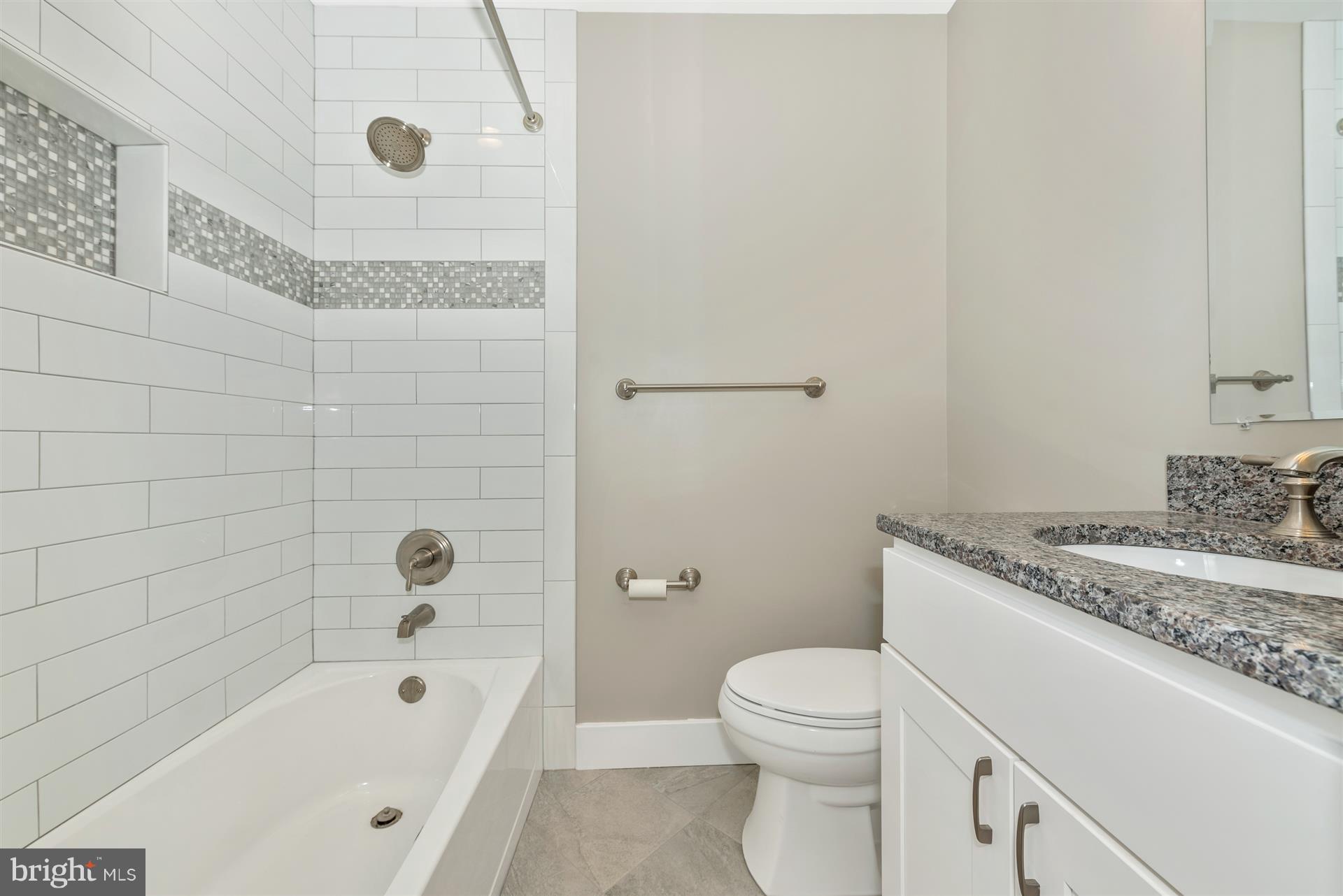 5008 Teen Barnes Road Frederick, MD 21703 - Photo 17 of 30 a bathroom with a granite countertop sink a toilet and bathtub