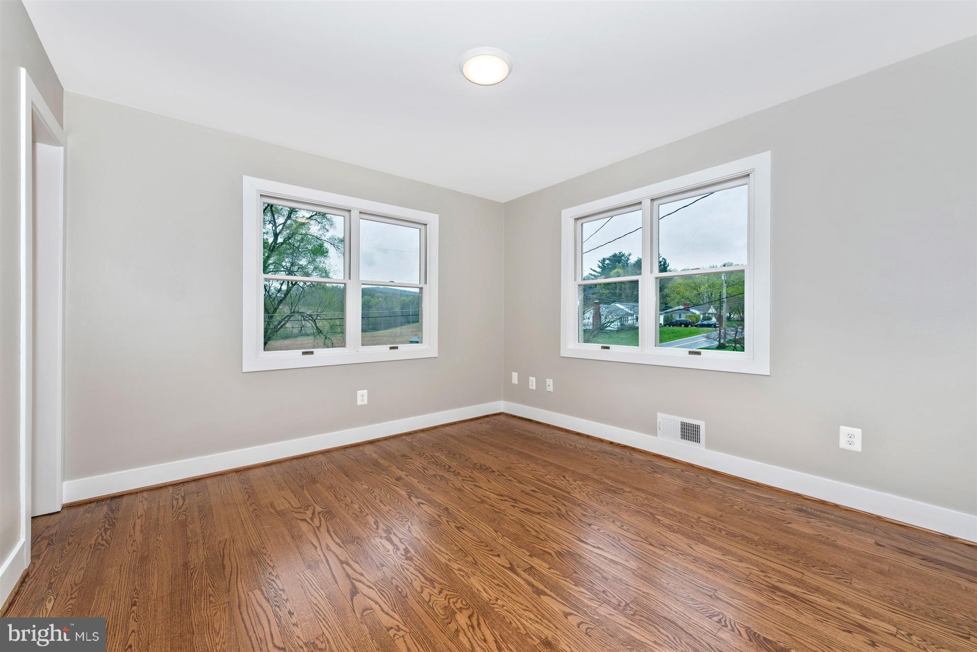 5008 Teen Barnes Road Frederick, MD 21703 - Photo 19 of 30 an empty room with wooden floor and windows