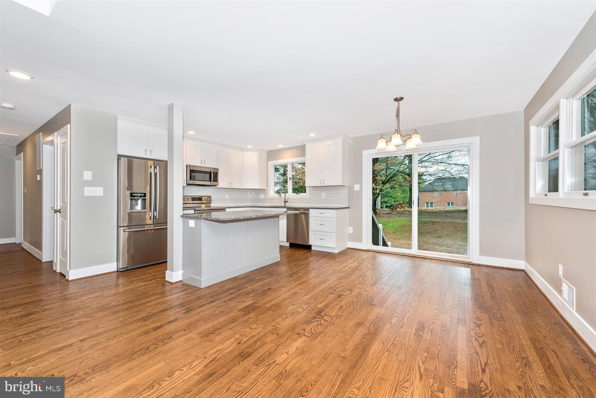 5008 Teen Barnes Road Frederick, MD 21703 - Photo 7 of 30 a view of a kitchen with wooden floor electronic appliances and furniture