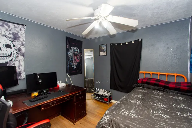 a bedroom with a bed and a desk