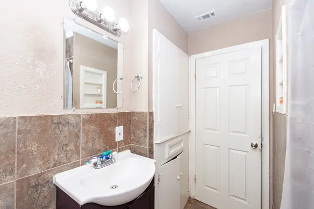 a bathroom with a sink a vanity and a mirror