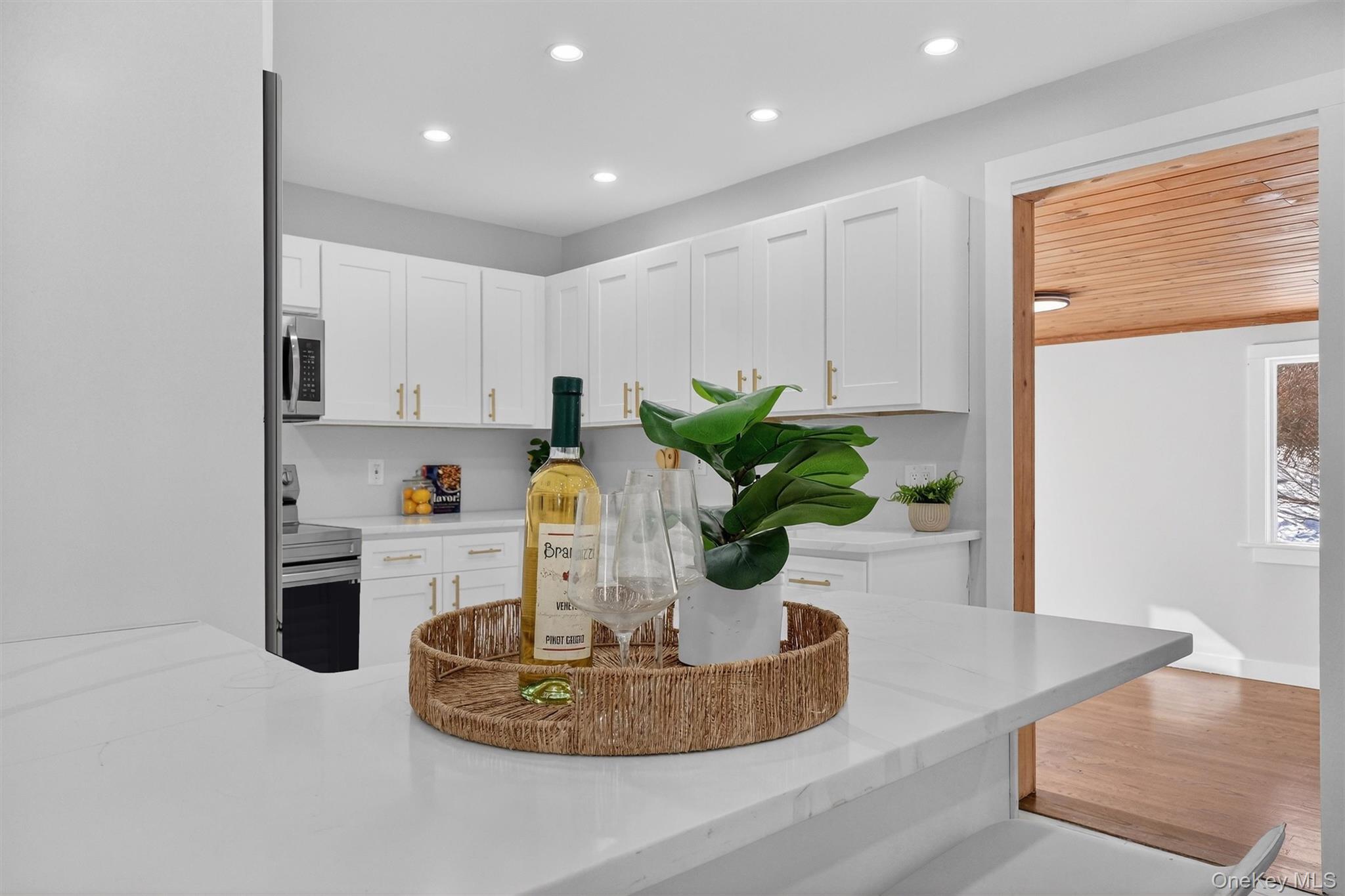 27 Franklin Road Hyde Park, NY 12538 - Photo 13 of 37 a kitchen with stainless steel appliances granite countertop a potted plant on the granite counter tops and a view of living room