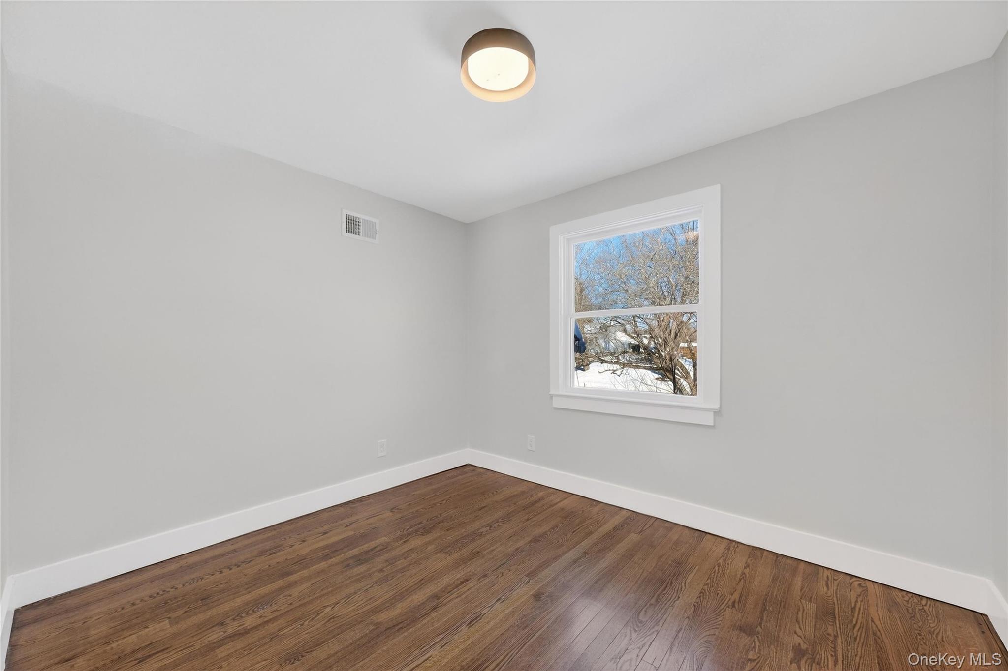 27 Franklin Road Hyde Park, NY 12538 - Photo 29 of 37 an empty room with wooden floor and a window