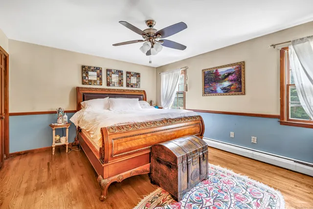 a bedroom with a large bed and a chandelier