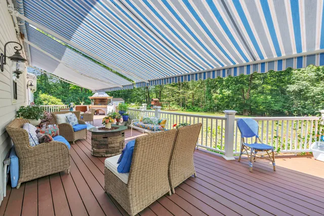a roof deck with table and chairs potted plants with wooden floor