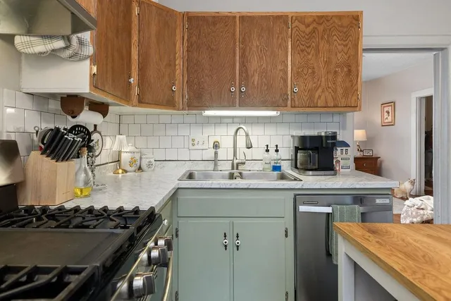 a kitchen with a sink stove and cabinets