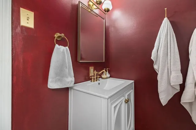 a bathroom with a sink vanity and mirror