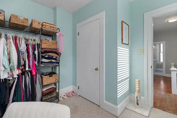 a view of walk in closet with clothes and shoes