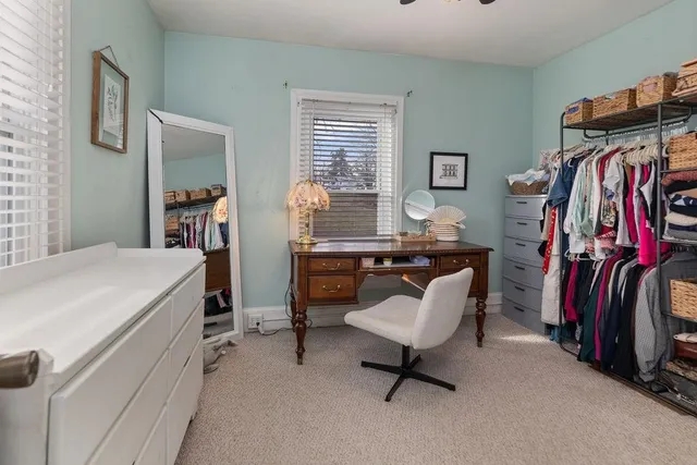 a living room with furniture and a air conditioner vent