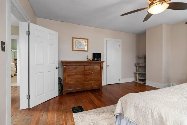 a bedroom with a bed and a dresser