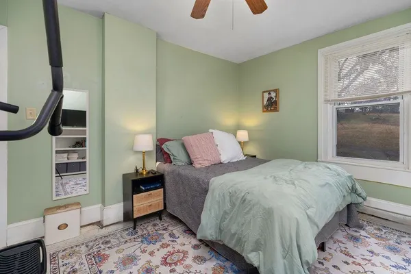 a bedroom with a bed and a window in it