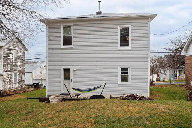a backyard of house with yard and seating area
