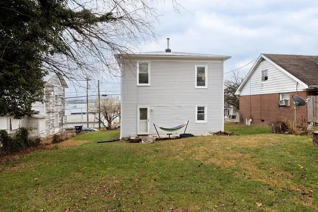 a backyard of a house with table and chairs