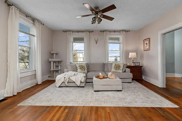 a living room with furniture and wooden floor