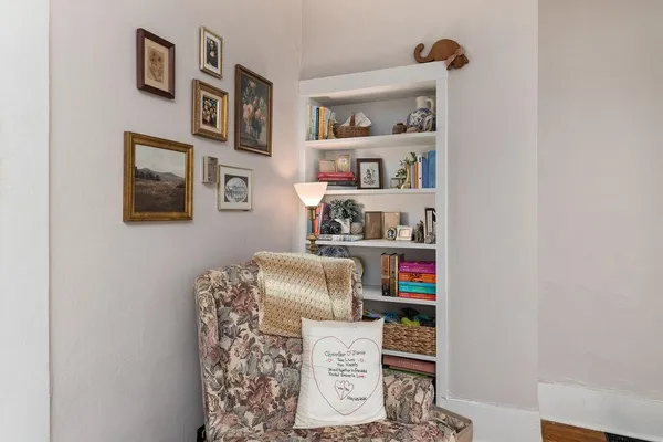 a room with a bookshelf and a wooden floor