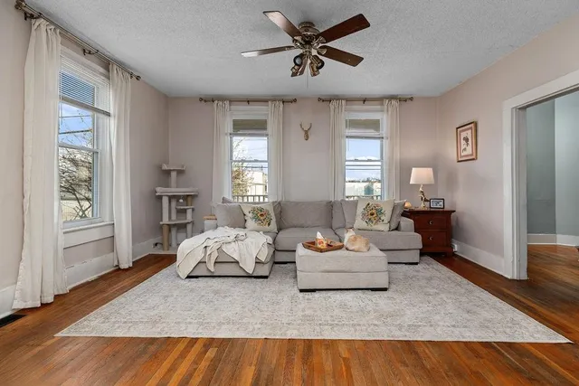 a living room with furniture and wooden floor