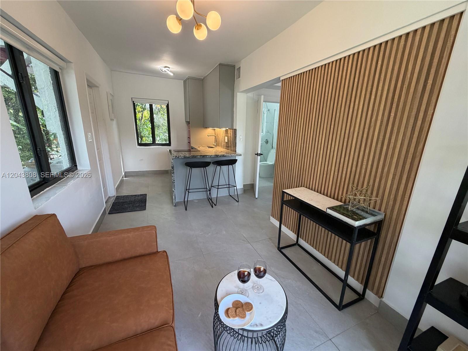 2134 Southwest 11th Street Miami, FL 33135 - Photo 11 of 13 a living room with furniture and a wooden floor